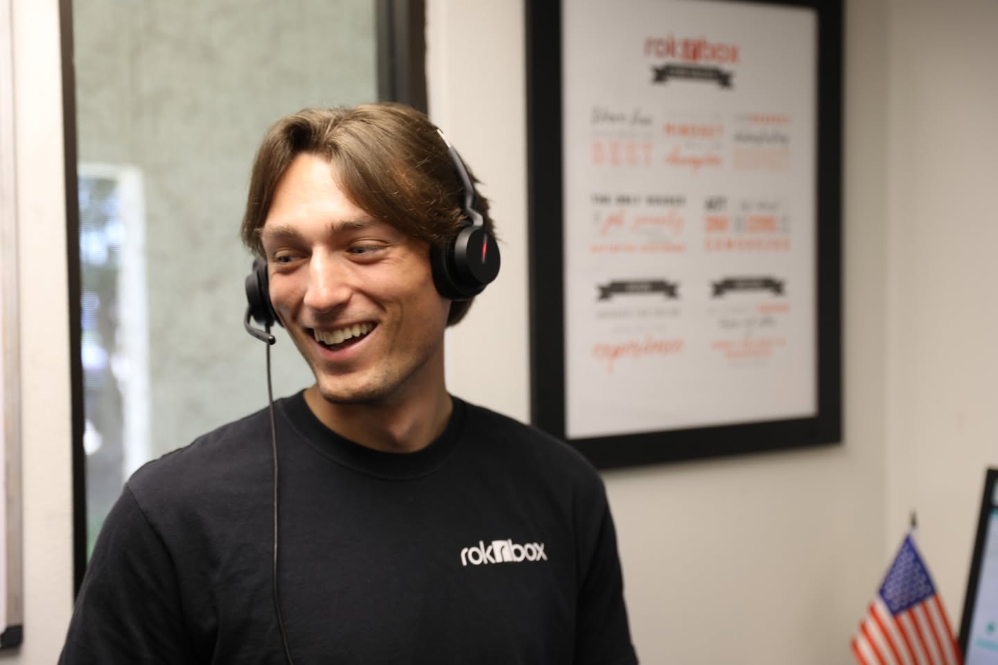 Rokrbox caller wearing a headset in the College Station office