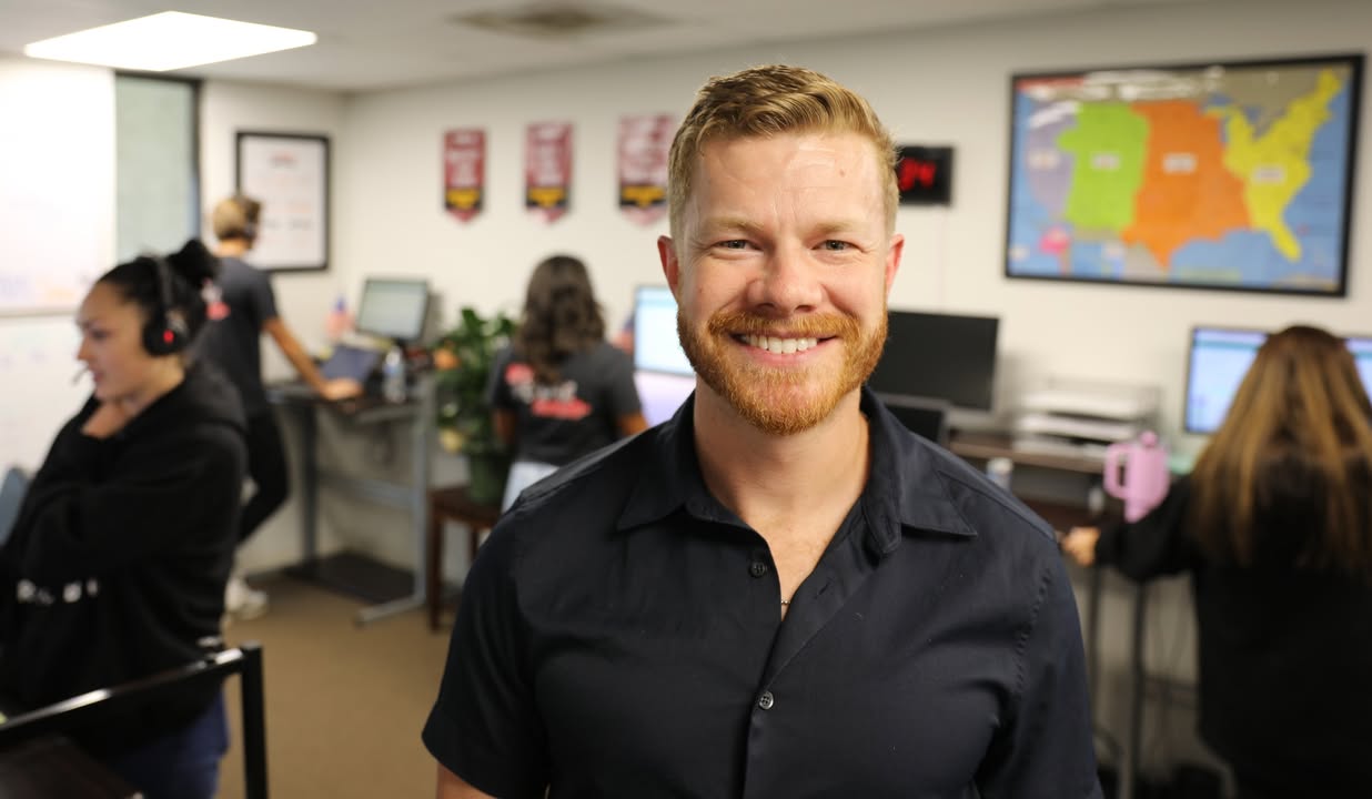 Rokrbox team member with callers working in the office behind him