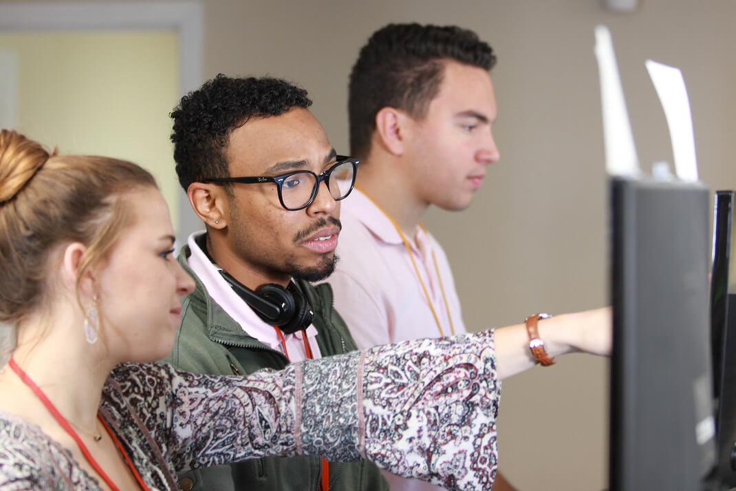 Rokrbox team reviewing information together at a workstation